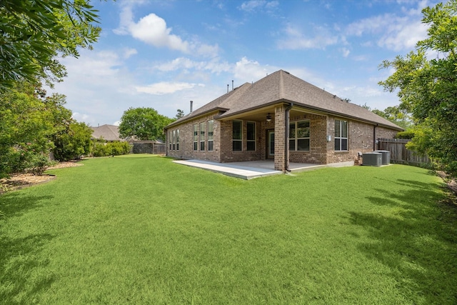 27208 Adrian Hills Ln, Spring, TX 77386 - back of property with brick siding, a patio, a shingled roof, central AC unit, and a ceiling fan