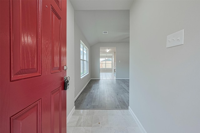 2706 Star Peak Dr, Houston, TX 77088 - entryway featuring baseboards, lofted ceiling, and light wood-type flooring