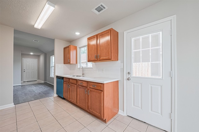 2706 Star Peak Dr, Houston, TX 77088 - kitchen featuring a sink, light tile patterned floors, light countertops, dishwashing machine, and backsplash