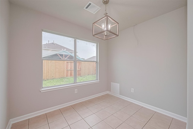 2706 Star Peak Dr, Houston, TX 77088 - empty room featuring a chandelier, light tile patterned floors, and baseboards