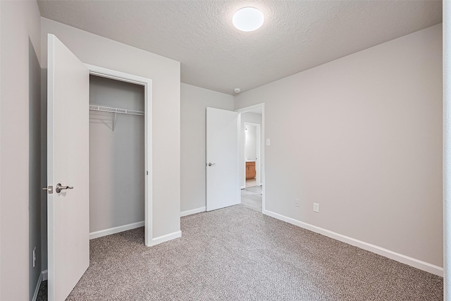 2706 Star Peak Dr, Houston, TX 77088 - unfurnished bedroom with carpet flooring, baseboards, a closet, and a textured ceiling
