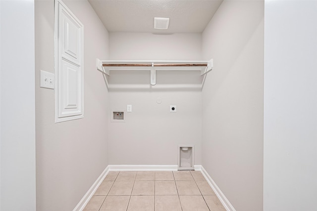 2706 Star Peak Dr, Houston, TX 77088 - laundry room with electric dryer hookup, light tile patterned floors, hookup for a washing machine, baseboards, and hookup for a gas dryer