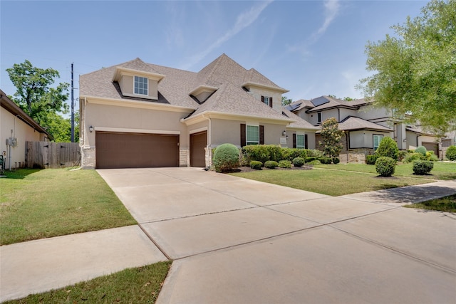 4218 Tanner Woods Ln, Sugar Land, TX 77479 - view of front of house featuring stucco siding, stone siding, driveway, roof with shingles, and an attached garage