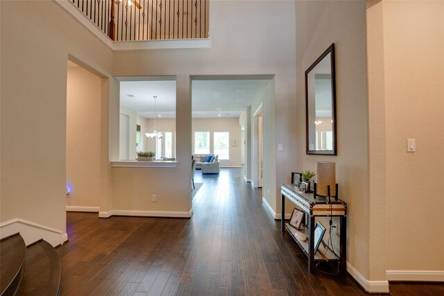 4218 Tanner Woods Ln, Sugar Land, TX 77479 - corridor with a chandelier, dark wood-style floors, a towering ceiling, and baseboards