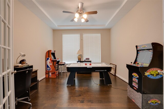 4218 Tanner Woods Ln, Sugar Land, TX 77479 - recreation room featuring a ceiling fan, a tray ceiling, dark wood-type flooring, and baseboards