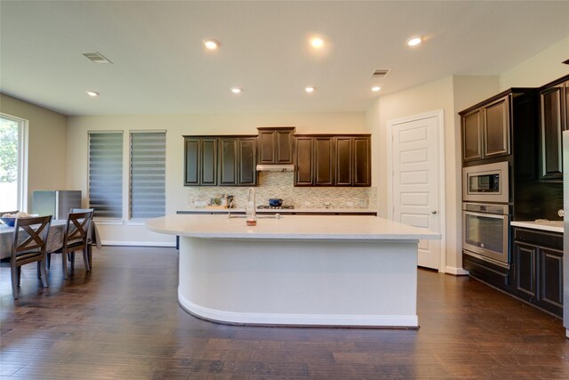 4218 Tanner Woods Ln, Sugar Land, TX 77479 - kitchen with stainless steel appliances, light countertops, a sink, backsplash, and recessed lighting