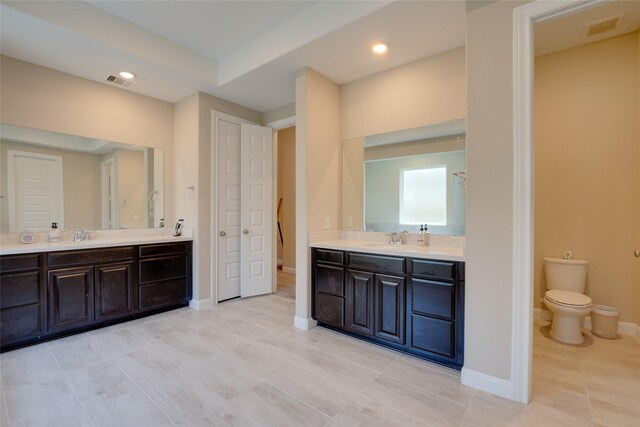 4218 Tanner Woods Ln, Sugar Land, TX 77479 - bathroom with two vanities, toilet, tile patterned floors, baseboards, and recessed lighting