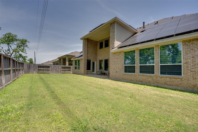4218 Tanner Woods Ln, Sugar Land, TX 77479 - rear view of house featuring brick siding, solar panels, and a patio