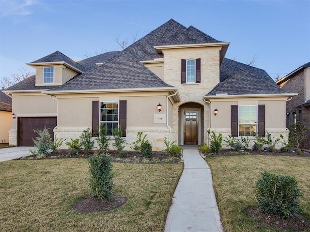 4218 Tanner Woods Ln, Sugar Land, TX 77479 - view of front of house with stucco siding, stone siding, roof with shingles, and an attached garage