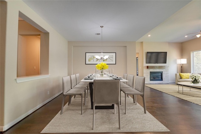 4218 Tanner Woods Ln, Sugar Land, TX 77479 - dining area featuring a stone fireplace, wood finished floors, baseboards, a chandelier, and recessed lighting