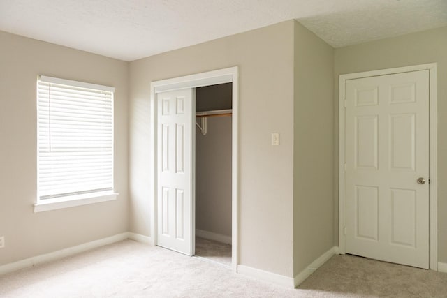 108 Chandler Dr, Baytown, TX 77521 - unfurnished bedroom with light colored carpet, multiple windows, and a closet