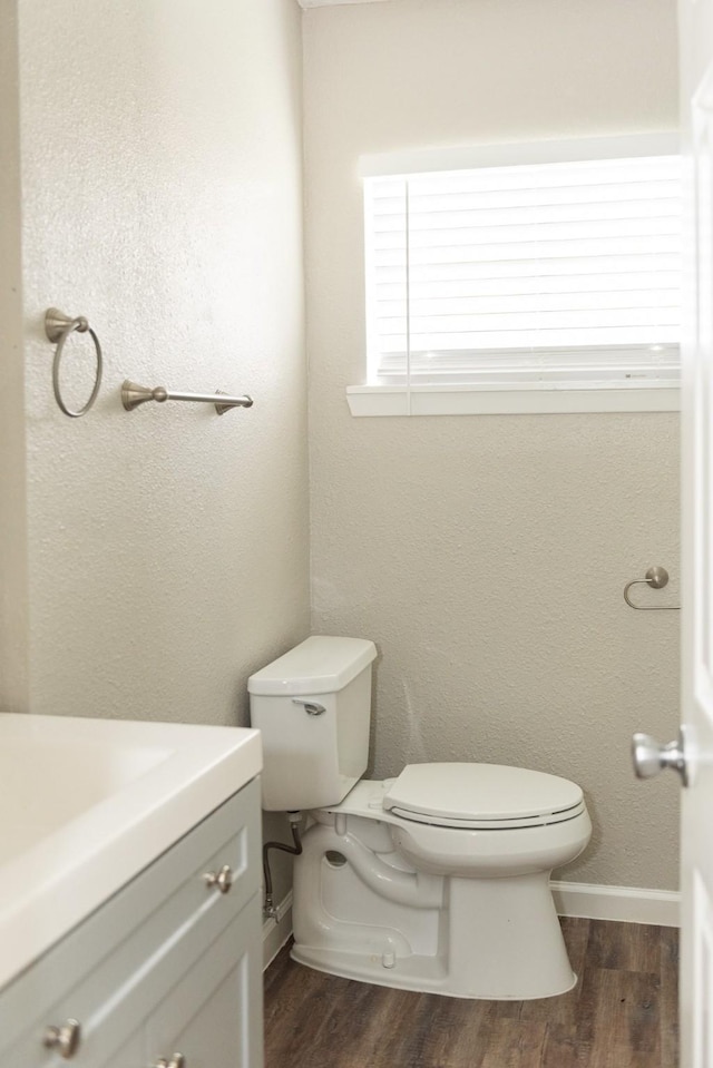 108 Chandler Dr, Baytown, TX 77521 - half bathroom with toilet, wood finished floors, vanity, and baseboards