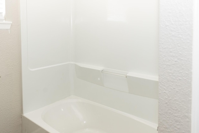 108 Chandler Dr, Baytown, TX 77521 - full bathroom with a tub and a textured wall