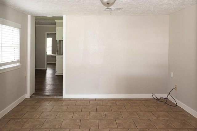 108 Chandler Dr, Baytown, TX 77521 - spare room with a textured ceiling and baseboards
