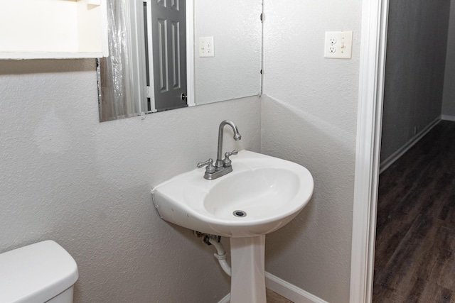 108 Chandler Dr, Baytown, TX 77521 - bathroom featuring wood finished floors and toilet