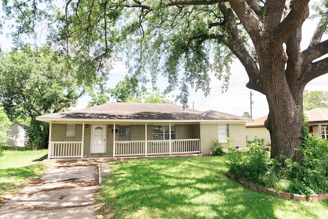 108 Chandler Dr, Baytown, TX 77521 - single story home with brick siding, a porch, and a front yard