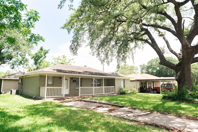 108 Chandler Dr, Baytown, TX 77521 - view of front of house featuring a porch, brick siding, central AC, and a front lawn