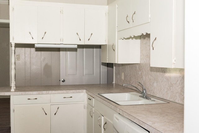 108 Chandler Dr, Baytown, TX 77521 - kitchen with a sink, light countertops, white dishwasher, decorative backsplash, and white cabinets