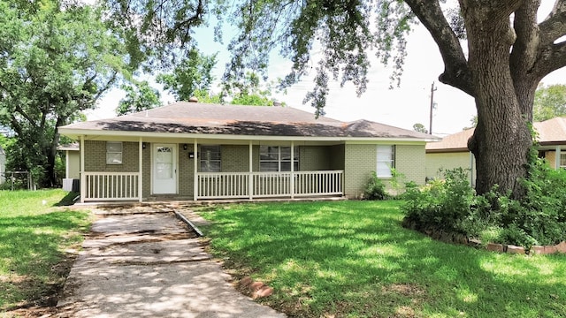 108 Chandler Dr, Baytown, TX 77521 - ranch-style house with covered porch, brick siding, and a front lawn