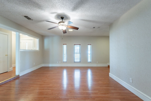 16466 Mandate Dr, Houston, TX 77049 - spare room featuring a ceiling fan, light wood finished floors, a textured ceiling, and baseboards
