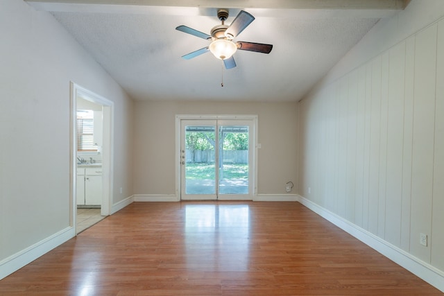16466 Mandate Dr, Houston, TX 77049 - empty room with light wood finished floors, ceiling fan, and baseboards