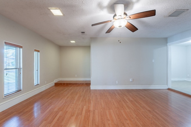 16466 Mandate Dr, Houston, TX 77049 - spare room with light wood-style flooring, a textured ceiling, baseboards, and ceiling fan