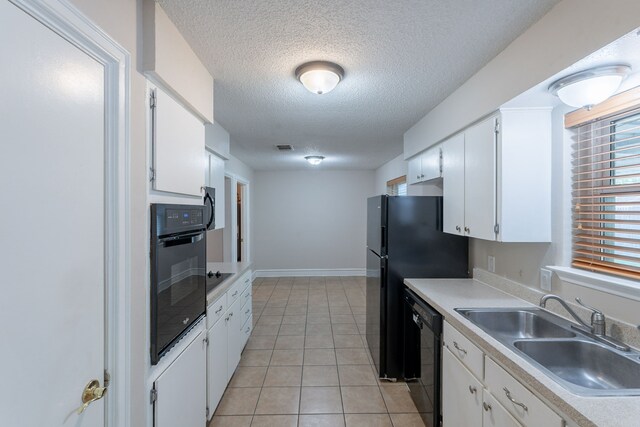 16466 Mandate Dr, Houston, TX 77049 - kitchen featuring black appliances, a sink, white cabinetry, a textured ceiling, and light countertops