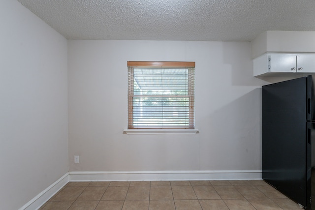 16466 Mandate Dr, Houston, TX 77049 - unfurnished room with a textured ceiling, baseboards, and light tile patterned floors