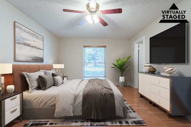16466 Mandate Dr, Houston, TX 77049 - bedroom featuring light wood-style floors, a textured ceiling, and ceiling fan