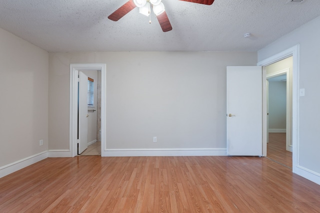 16466 Mandate Dr, Houston, TX 77049 - spare room featuring a ceiling fan, light wood-type flooring, baseboards, and a textured ceiling