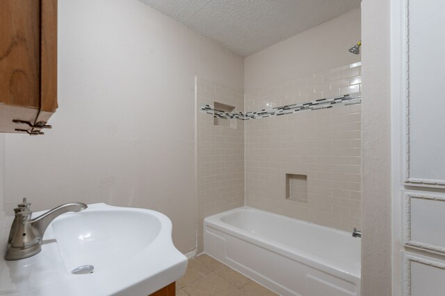 16466 Mandate Dr, Houston, TX 77049 - bathroom with a sink, a textured ceiling, tub / shower combination, and tile patterned floors
