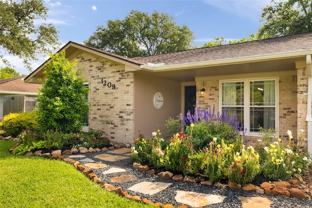 1209 Kansas Ave S, Anahuac, TX 77514 - view of front of house with brick siding and a shingled roof