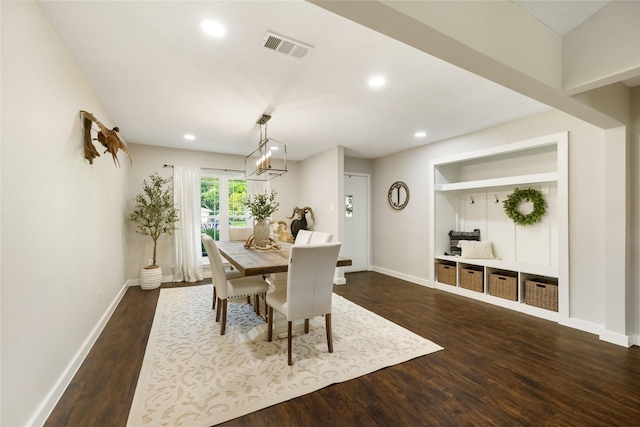 1209 Kansas Ave S, Anahuac, TX 77514 - dining space featuring baseboards, dark wood finished floors, recessed lighting, and a chandelier