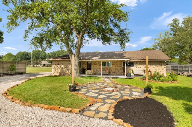 1209 Kansas Ave S, Anahuac, TX 77514 - back of property with a patio area and brick siding