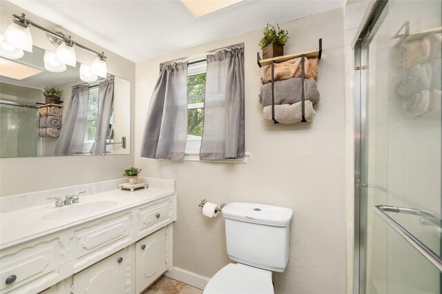 1209 Kansas Ave S, Anahuac, TX 77514 - full bathroom with a shower stall, toilet, vanity, and baseboards