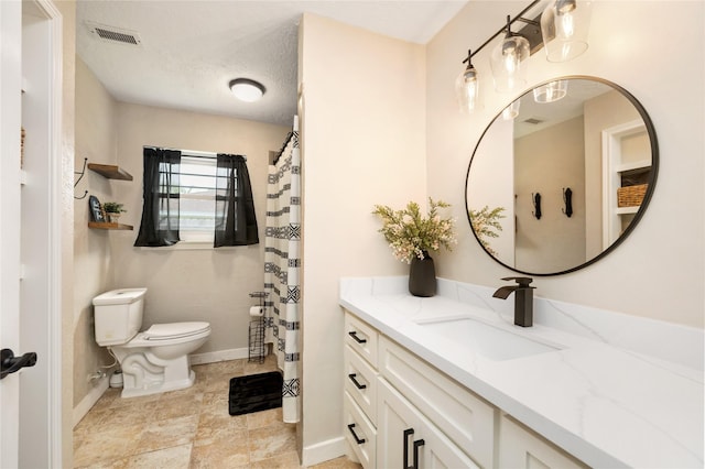1209 Kansas Ave S, Anahuac, TX 77514 - bathroom featuring toilet, baseboards, and vanity