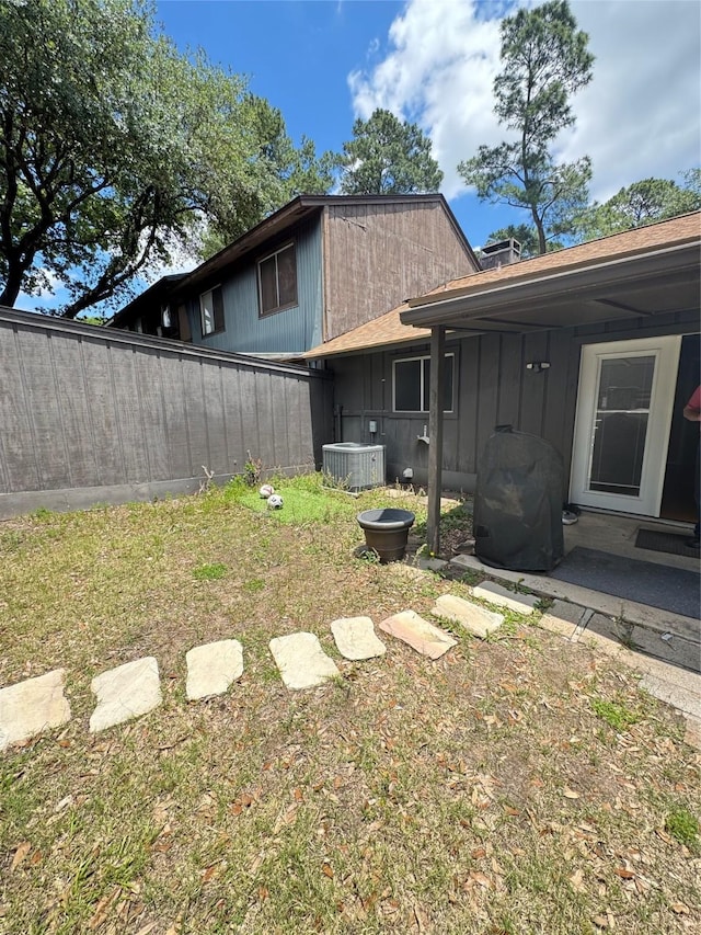 618 Hickory St, Huntsville, TX 77320 - rear view of house featuring central AC unit