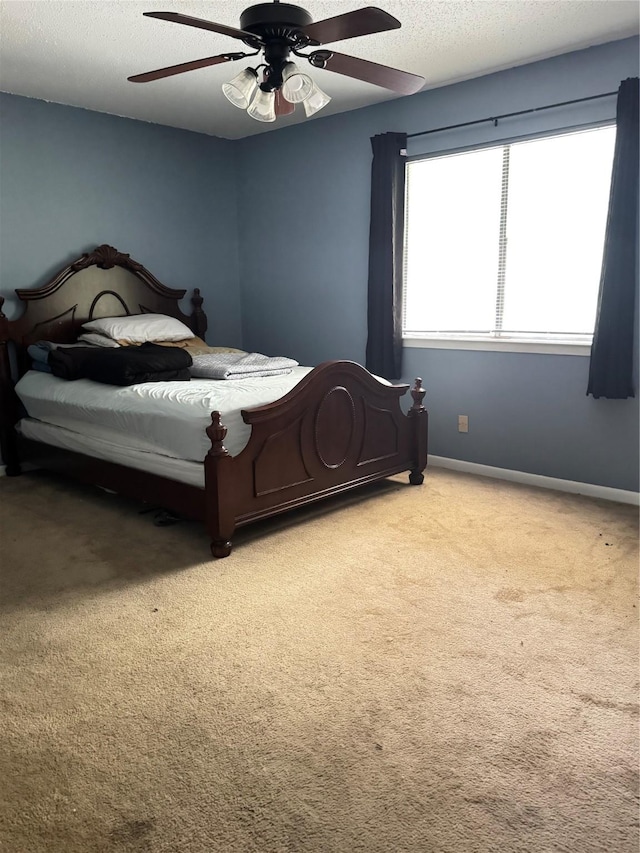618 Hickory St, Huntsville, TX 77320 - carpeted bedroom featuring baseboards, a ceiling fan, and a textured ceiling