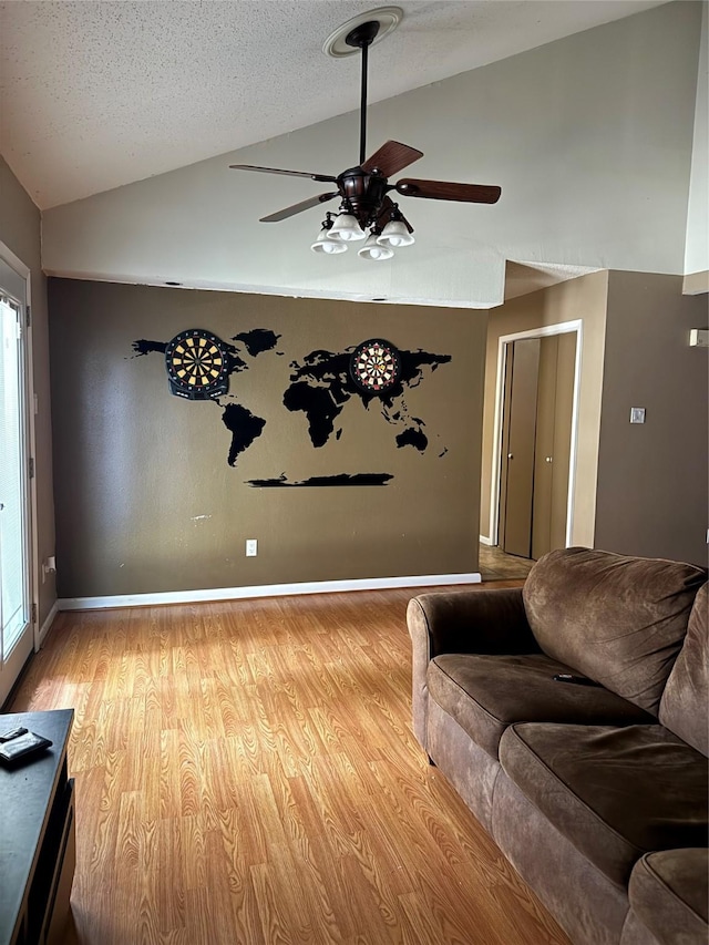 618 Hickory St, Huntsville, TX 77320 - living room featuring a ceiling fan, light wood-type flooring, baseboards, and high vaulted ceiling