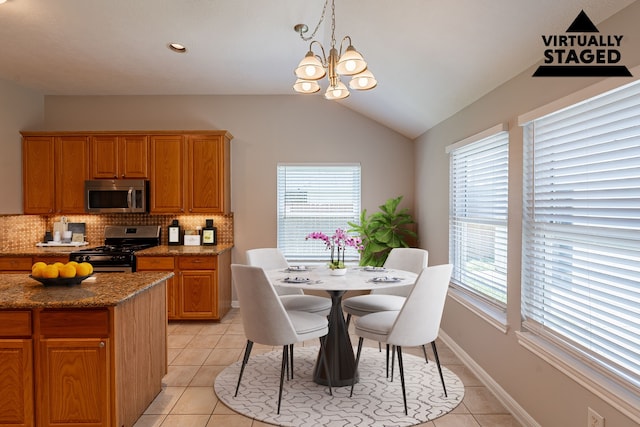 18307 Shadow Grove Ln, Crosby, TX 77532 - dining area featuring light tile patterned floors, a chandelier, vaulted ceiling, and baseboards