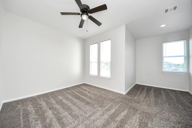 273 Rd 5134, Cleveland, TX 77327 - empty room featuring healthy amount of natural light, dark colored carpet, a ceiling fan, and baseboards