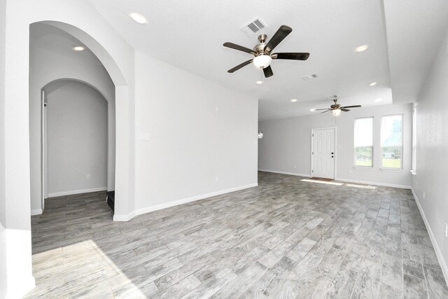 273 Rd 5134, Cleveland, TX 77327 - unfurnished living room featuring arched walkways, ceiling fan, recessed lighting, wood finished floors, and baseboards