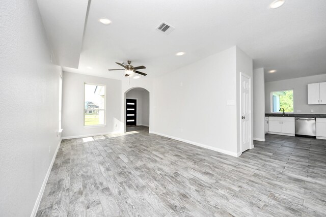 273 Rd 5134, Cleveland, TX 77327 - unfurnished living room featuring arched walkways, ceiling fan, light wood-style flooring, a sink, and recessed lighting