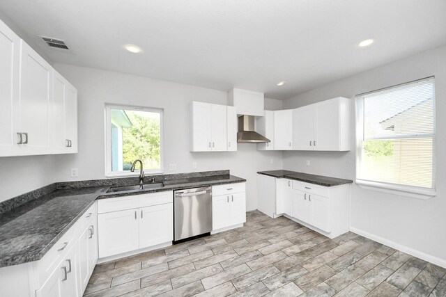 273 Rd 5134, Cleveland, TX 77327 - kitchen with stainless steel dishwasher, a sink, wall chimney exhaust hood, dark stone countertops, and recessed lighting