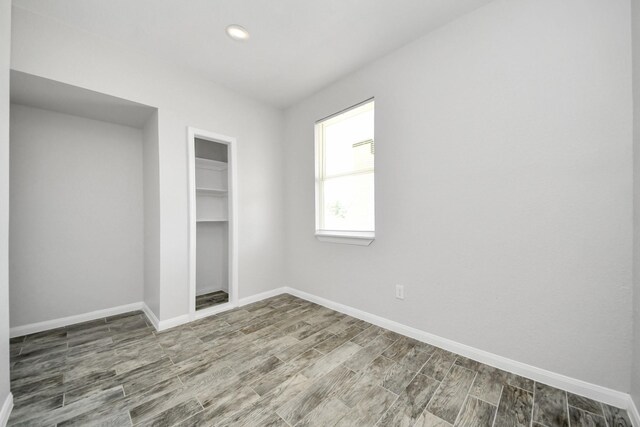 273 Rd 5134, Cleveland, TX 77327 - unfurnished bedroom with wood finish floors, baseboards, a closet, and recessed lighting