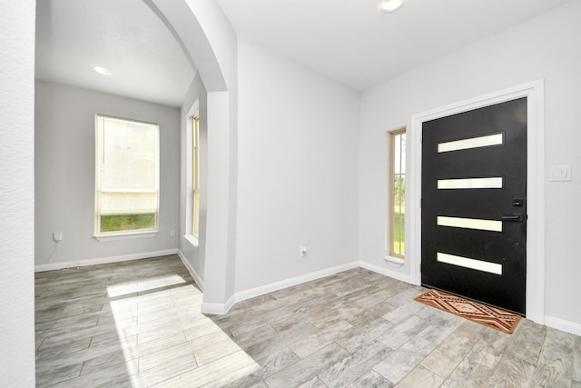 273 Rd 5134, Cleveland, TX 77327 - entryway featuring arched walkways, healthy amount of natural light, wood finished floors, and baseboards