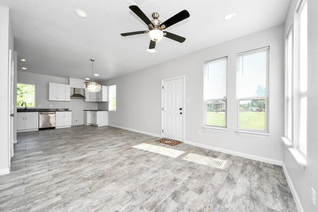 273 Rd 5134, Cleveland, TX 77327 - unfurnished living room featuring baseboards, light wood-style flooring, recessed lighting, and a ceiling fan