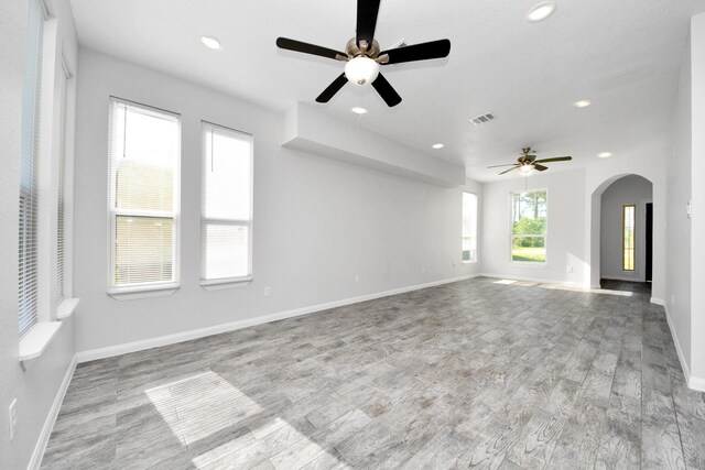 273 Rd 5134, Cleveland, TX 77327 - unfurnished living room with a ceiling fan, arched walkways, wood finished floors, recessed lighting, and baseboards