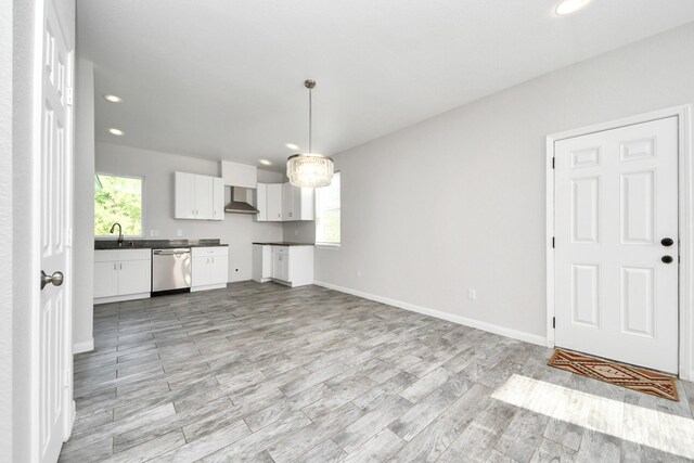 273 Rd 5134, Cleveland, TX 77327 - kitchen with dishwasher, wall chimney exhaust hood, a sink, white cabinets, and recessed lighting
