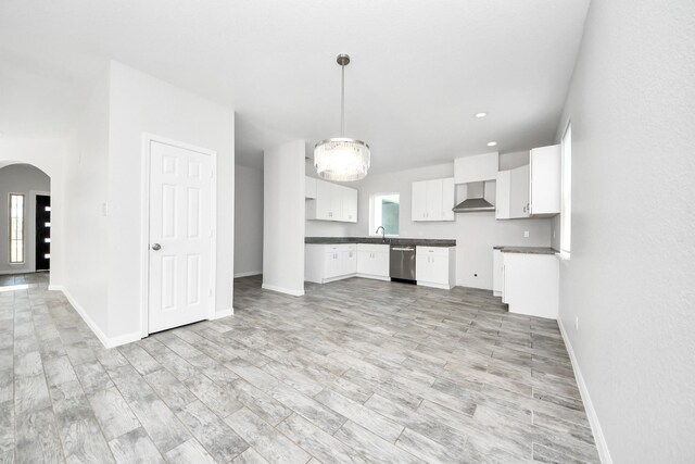 273 Rd 5134, Cleveland, TX 77327 - kitchen with stainless steel dishwasher, white cabinets, wall chimney exhaust hood, healthy amount of natural light, and recessed lighting